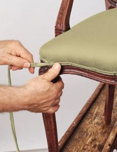 a person is holding the back of a chair