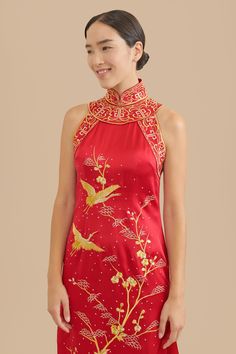 Say hello to your inner warrior princess while wearing this one-of-a-kind, hand embroidered Chinese wedding cheongsam dress. Admire the intricate, yet dramatic high mandarin collar paired with a modern halter top. Zoom in to see the elegant hand-embroidered cranes delicately sewn throughout the body and train of the qipao. If Mulan had a powerful outfit for her Chinese wedding, this would be it. Pair this with our Ruby hairpin to fully unleash all the power and beauty within you. Check out addit Sleeveless Ao Dai For Wedding, Embroidered Cheongsam For Ceremonies, Qipao Wedding Dress, Chinese Dress Modern, Cheongsam Wedding Dress, Wedding Tea Ceremony, Vietnamese Wedding Dress, Tea Ceremony Dress, Chinese Wedding Dress Traditional