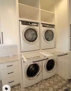 a washer and dryer in a white laundry room