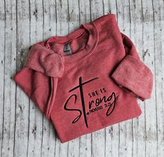 This listing is for a Heather sport scarlett red colored sweatshirt with She is Strong embroidered on it. This is NOT a heat press design. This is machine embroidered with thread. Red Letter Embroidery Sweatshirt For Fall, Red Long Sleeve Sweatshirt With Embroidered Graphics, Red Embroidered Text Sweatshirt For Fall, Red Cotton Sweatshirt With Embroidered Text, Red Embroidered Sweatshirt For Fall, Red Sweatshirt With Custom Embroidery For Fall, Red Casual Sweatshirt With Custom Embroidery, Red Crew Sweatshirt With Letter Print, Red Crew Neck Sweatshirt With Embroidered Graphics