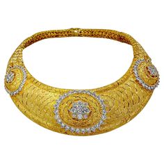 This gorgeous choker is expertly crafted in 18K yellow gold, and features three raised diamond motifs in the front. The backdrop for the motif of diamonds exhibits an intricate "scale" pattern with a Florentine finish. The necklace has a classical and regal presence. On the reverse side is a honeycomb gold gallery that also exhibits the expert quality workmanship of the maker. The combination of Florentine finish and its subtle pattern, make this amazing choker both versatile and wearable. The n Traditional Yellow Gold Necklaces With Diamond Accents, Traditional Yellow Gold Necklaces With Single Cut Diamonds, Traditional Gold Necklaces With Diamond Accents, 22k Gold Bridal Necklace For Anniversary, Luxury Gold Bridal Necklace For Anniversary, Luxury Celebration Necklaces With Single Cut Diamonds, Formal Gold Plated Diamond Necklace, 22k Gold Diamond Cut Jewelry For Formal Events, 22k Gold Diamond Cut Jewelry For Formal Occasions