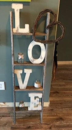 an old ladder with letters spelling out the word love