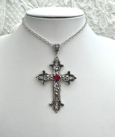 This necklace features a large detailed cross pendant accompanied by a high quality, finely cut glass jewel which hangs from a silver bail. The cross is approximately 7.7cm in length, this measurement does not include the pendant bail. There are 2 chain length options available: Standard Necklace, the overall length is 20 inches including a 5 inch chain extender so that it can be worn between 15-20 inches. Long Necklace, the overall length is 30 inches including a 6 inch chain extender so that it can be worn between 24-30 inches. Materials include; silver plated copper, silver plated brass and glass. This item is not made from sterling silver. If you have any questions about this item, you are more than welcome to contact darklingbeloved@gmail.com Red Cross Necklace, Cross Gothic, Detailed Cross, Red Gothic, Pendant Bail, Gothic Pendant, Grunge Jewelry, Pendant Bails, Jewel Necklace