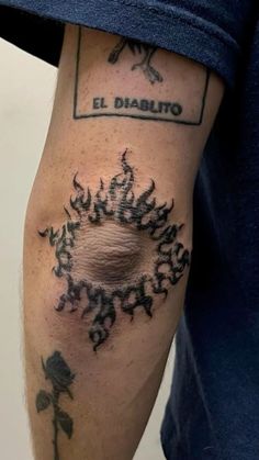 a man with a tattoo on his arm that says el diablito and has a rose in it