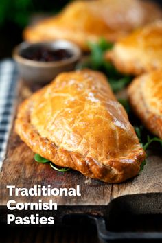 traditional scottish pasties on a cutting board with dipping sauces in the background and text overlay reading traditional english pastries