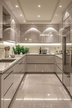 a modern kitchen with stainless steel appliances and white counter tops, along with glass cabinets