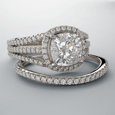 two wedding rings with an oval cut diamond surrounded by round brilliant pave set diamonds