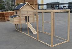 a large wooden chicken coop sitting on top of a parking lot