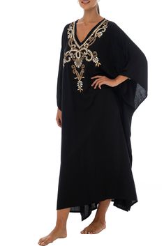 Add a tribal twist to your beach time in this black and gold summer maxi swimwear cover up. Zigzag embroidery adds a spicy accent to this long beach caftan, with a casual vacation vibe and a loose flowy fit that works beautifully on plus sizes. It offers great sun coverage, and is so easy to wear for cruises, lounging, vacation or relaxing days at the beach. Back From Bali is dedicated to creating beautiful, quality clothing with a heart. All of our items are crafted, sewn and painted by hand in Bali, by local artists and women who own small home businesses. For over 20 years, we have nurtured fair, honest and caring relationships with our artisans and their families – so you can feel as good about wearing our products as they feel about making them. Make waves in this black summer maxi sw