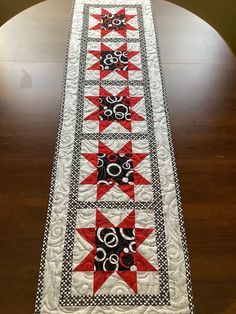 a table runner with red and black stars on it