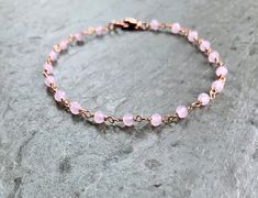 Rose Quartz Bracelet in rose gold fill This dainty circlet features wire-wrapped pink quartz beads. These stones absolute glow! Extra lovely in the rose gold finish - the colors are so complementary. With 14K rose gold-filled clasp components. Boho, graceful, and utterly charming. Also available in ANKLET sizes Rose Pink Quartz - faceted rondelles, approximately 3mm Stones are wrapped in rose gold-plated brass wire Bracelet pictured measures 7 inches in length Fastens with rose gold filled lobst Adjustable Dainty Rose Gold Rosary Bracelet, Adjustable Rose Gold Dainty Rosary Bracelet, Dainty Adjustable Rose Gold Rosary Bracelet, Dainty Rose Gold Beaded Bracelets With Rose Quartz, Bracelet Rosary, Bracelet Rose Gold, Rose Quartz Bracelet, Dainty Bracelet, Rosary Chain