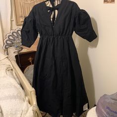 This Dress Is Brand New With Tags In A Size 6 Very Full And Zips And Ties In Bows In The Back. I Believe It’s Meant To Be Oversized And Would Easily Fit Up To A Size 10 Since The Waist Is Stretchy. Made Out Of A Medium Weight Cotton Fabric With An Inside Liner. It Kind Of Reminds Me Of A Dress That You Would Wear In The 80’s. Sorry About The Wrinkles, But It Would Come With Wrinkles When It Is Mailed To You As Well. Black A-line Puff Sleeve Dress For Spring, Spring Black Cotton Midi Dress, Black Cotton Midi Dress For Spring, Black Puff Sleeve Dress With V-neck For Summer, Black Cotton Puff Sleeve Dress For Spring, Black Puff Sleeve Dress For Daywear, Black Midi-length Puff Sleeve Dress For Brunch, Black Midi-length Puff Sleeve Dress For Date Night, Black Puff Sleeve Midi Dress For Date Night