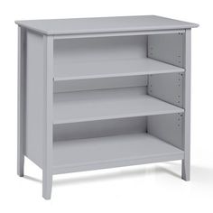 a white book shelf with two shelves on the bottom and one shelf below it, in front of a white background