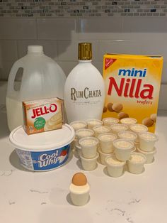 the ingredients to make an ice cream dessert are displayed on a counter top, including yogurt and almonds