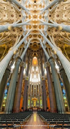 the inside of a cathedral with rows of pews