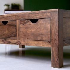 a close up of a wooden table with drawers