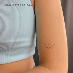 a woman's arm with a small tattoo on the left side of her arm