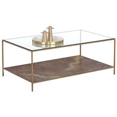 a coffee table with a metal base and glass top