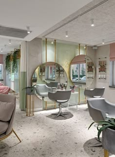 a salon with mirrors and chairs in it