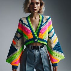 a woman wearing a colorful knitted jacket and jeans