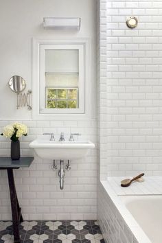 a white bathroom with two sinks and a bathtub