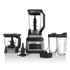 three blenders sitting next to each other on a white surface