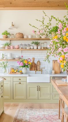 a kitchen filled with lots of flowers and greenery