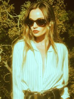 a woman wearing sunglasses and a leopard print skirt