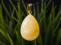 A fascinating handcrafted yellow landscape amber pendant will become not only an exquisite piece of jewelry, but also a true work of art. This unique piece, made from a piece of rare landscape amber of the highest quality, impresses with its unique patterns and elegant shape. Details: -Materials: natural amber -Metal: sterling silver, gold plated -Color: yellow  -Weight:7.9 g -Total length pendant: 4.5 cm  -Stone size length: 3.1 cm   -Stone size width: 2.5 cm   Amber is not just a beautiful stone, it is a treasure that holds the history of millions of years. It is formed from the sap of coniferous trees that lived millions of years ago. This process takes millions of years, making amber one of the oldest jewelry materials on Earth. Landscape amber is a special type of amber that contains Handmade Yellow Baltic Amber Necklace, Handmade Yellow Baltic Amber Necklaces, Handmade Baltic Amber Necklace In Yellow, Elegant Yellow Baltic Amber Necklaces, Yellow Baltic Amber Teardrop Jewelry, Yellow Baltic Amber Jewelry For Gifts, Yellow Landscape, Earth Landscape, Coniferous Trees