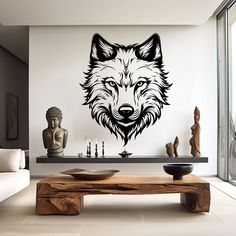 a living room with a coffee table and wall decal in the shape of a wolf's head