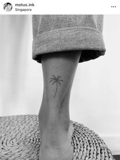 a small palm tree tattoo on the ankle