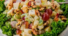 a close up of a salad with grapes and nuts