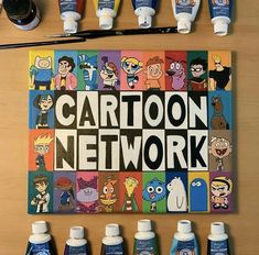 the cartoon network poster is surrounded by paint bottles