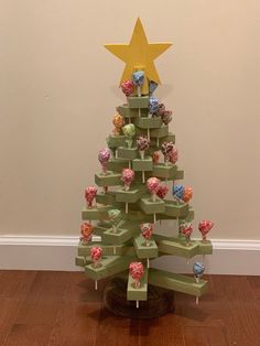 a small christmas tree made out of wooden blocks with candy candies on them and a star