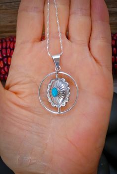 This pendant is handcrafted with Sterling Silver and is set with Turquoise and Coral stones into a concho design. This pendant features a spinner that allows you to turn to the side you want. You can wear it as a Turquoise pendant one day, and a Coral pendant the next. The styling is soft, modern, and lightweight. It'll compliment any outfit that is worn with this. Measures: 1 11/16” x 1 1/8” Includes 20" Silver Chain Vintage never worn Turquoise Concho Necklace As Gift, Sterling Silver Concho Pendant Jewelry, Artisan Turquoise Concho Necklace Gift, Concho Sterling Silver Necklace For Gifts, Sterling Silver Concho Necklace For Gift, Southwestern Sterling Silver Concho Necklace, Bohemian Sterling Silver Necklace With Concho, Southwestern Style Concho Pendant Jewelry, Southwestern Style Turquoise Round Pendant Necklace