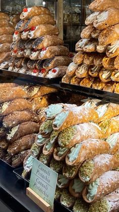 many different types of pastries on display in a store