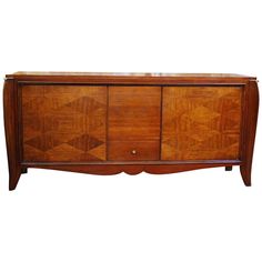 an old wooden sideboard with two doors and drawers