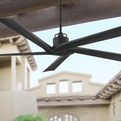 an outdoor ceiling fan in front of a house