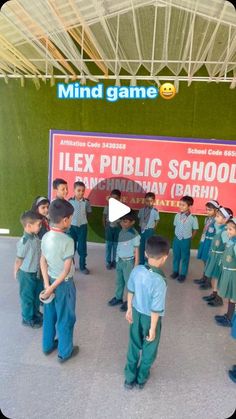 a group of children standing in front of a sign