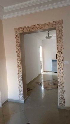 an empty room with a large mirror on the wall and tile flooring in front of it