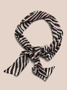 Wear it as a belt, tie it in your hair, or wrap it around the handle of your bag, this patterned scarf is extra-long for maximum possibilities, crafted in luxuriously soft and sheer silk crepe.  Length: 71" (180cm) Width: 7" (17. 8cm) Hand wash cold, Elegant Silk Scarves For Beach, Chic Brown Silk Scarf, Elegant Brown Silk Scarf For Summer, Chic Square Formal Scarves, Chic Square Scarf For Formal Occasions, Chic Square Scarves For Formal Occasions, Elegant Adjustable Scarf Neckwear, Elegant Summer Scarf With Ties, Chic Square Silk Scarves