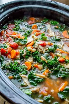 a crock pot filled with soup and vegetables