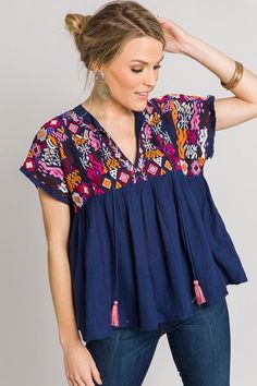 Casual Blue Tops With Tassel Ties, Blue Spring Tops With Tassel Ties, Bohemian Blue Tops With Tassel Ties, Blue Bohemian Tops With Tassel Ties, Blue Spring Top With Tassel Ties, Blue Bohemian Top With Tassel Ties, Bohemian Blue Top With Tassels, Blue Tassel Blouse For Summer, Bohemian Pink Tops With Tassels