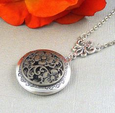 This elegant locket is 28 inches long. Antique finished round silver locket has beautiful engraved floral patterns on the sides. I have set a antique silver finished gothic style medallion filigree on the locket. Necklace is hanging from antique silver link. Heirloom locket is finished with antique silver chain and silver lobster clasp. Locket is 32mm in size. It has room for two photos inside! Please note: I DO NOT DO ENGRAVING OR INSERT PICTURES! Thanks for looking:) Mani Antique Silver Gothic Round Jewelry, Ornate Silver Jewelry With Engraving Option, Oxidized Round Pendant Jewelry For Wedding, Oxidized Finish Round Pendant For Wedding, Victorian Silver Locket Necklace For Anniversary, Antique Silver Locket Necklace For Wedding, Nickel-free Silver Locket Necklace For Wedding, Victorian Silver Round Pendant Locket Necklace, Etched Pendant Locket Necklace For Wedding