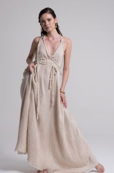 The Athena Goddess Gown is skillfully handcrafted and draped with the Greek technique to awaken the goddess in you. Elegant and beautiful casual creation. The free-flowing silhouette can be belted into a form-fitting dress with strings of handmade braids around your hips or waist. Each dress is meticulously handmade in soft 2 layers of cotton fabric and then individually hand-dyed with non-toxic dyes. Rich tones are inspired by the nature and ancient walls of a historic city. A uniquely designed Bohemian Beige Wrap Dress, Beige Bohemian Wrap Dress, White Bohemian Wrap Dress, Dress With Strings, Greek Goddess Dress, Greek Dress, Bohemian Dresses Long, Dress Boho Wedding, Goddess Gown