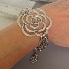 The BLOOMY ROSE is a statement eye catching bracelet that features a large antique silver rose which is attached to three chunky silver cable chains on each side . There's a little rose dangling at the the of the extension chain ... Stunning! - Length is adjustable 6.5" to 8" . - Chain and components are stainless steel. -  Rose is silver pewter My jewelry is designed and handcrafted by me. I only make small batches of one design.  Complimentary gift-ready packaging. --SHIPPING-- * Zero cost . S Silver Double Strand Jewelry With Chunky Chain, Silver Jewelry With Chunky Double Strand Chain, Silver Multi-strand Jewelry With Unique Variations, Bohemian Silver Chain Metal Bracelet, Chic Silver Multi-strand Jewelry, Nickel-free Multi-strand Silver Bracelets, Elegant Silver Double Chain Bracelet, Silver Multi-strand Chain Bracelet Gift, Metal Chain Bracelet For Layering