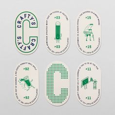 four green and white stickers with the letter c on them