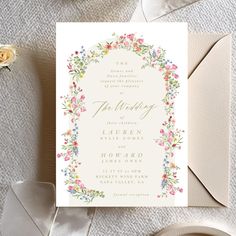 the wedding stationery is laid out on top of a table with flowers and ribbons