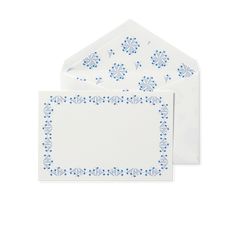 two white envelopes with blue flowers on the front and bottom, one is blank