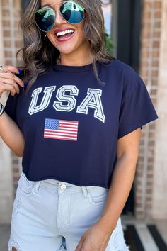 Rock this Navy Flag Short Sleeve Graphic Tee and show off your patriotic side. Made with soft, high-quality fabric, this tee features a bold navy flag design that is perfect for the Fourth of July or any day. Plus, the short sleeves keep you cool and comfortable all day long. Fit: She is wearing her true size medium. Fits true to size. If in between sizes, size down. Fourth Of July Outfits, Navy Flag, July Outfits, Spring Staples, Tank Romper, The Fourth Of July, 4th Of July Outfits, Flag Design, New Arrival Dress